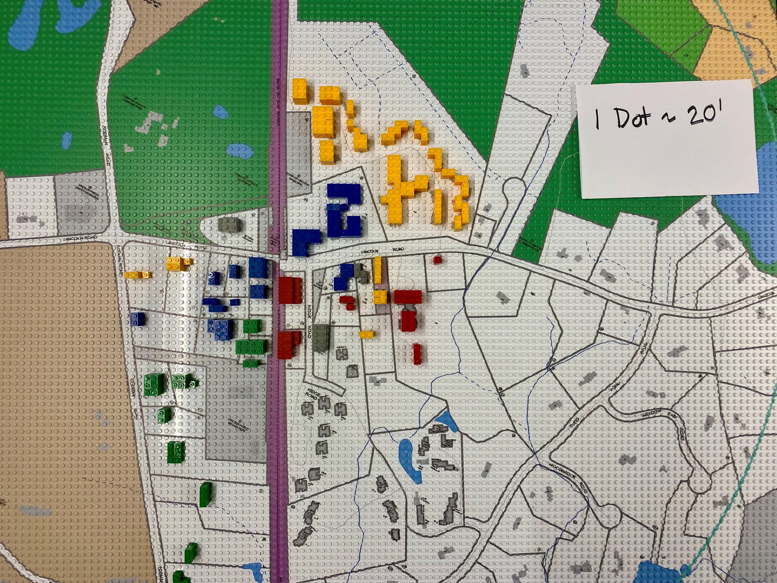 A lego board with blocks representing buildings in town.